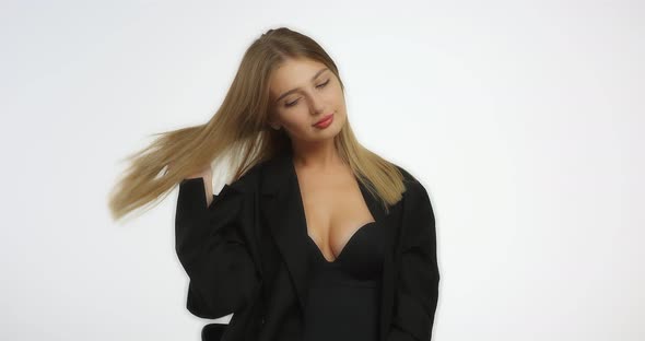 Beautiful Young Woman Poses in the Studio on Camera on a White Background