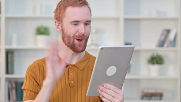 Portrait of Redhead Man Doing Video Chat on Tablet