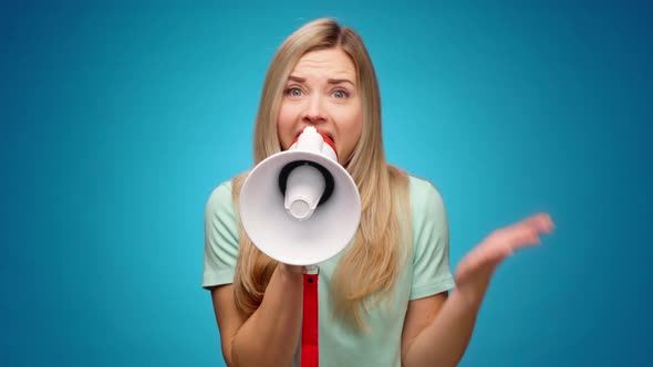 Blonde Young Woman Announcing Something Using Loudspeaker Against Blue Background