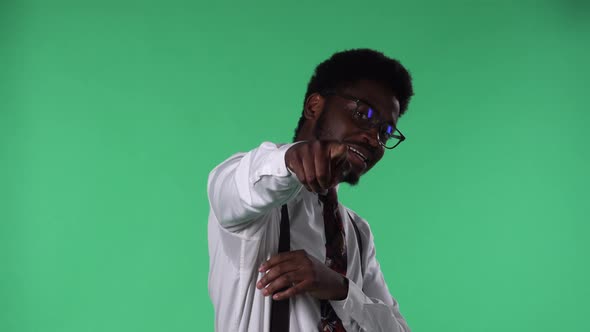 Portrait of Young African American Man Smiling Telling Something Interesting and Pointing to