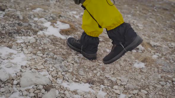 Male Tourist Is Walking in Mountains in Daytime, Close-up View of Feet Shod