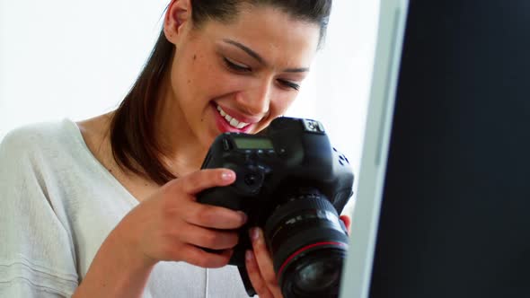 Photographer looking at photos on digital camera