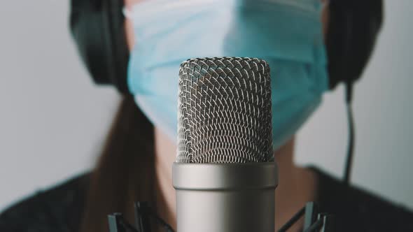 Healthcare Worker in Call Center with Medical Mask Speaking Into the Microphone. Covid-19 Support