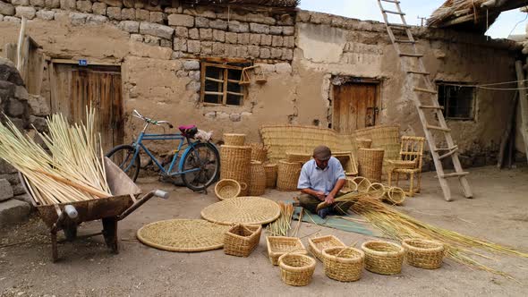 Man Weaving Traditional Bamboo Basket