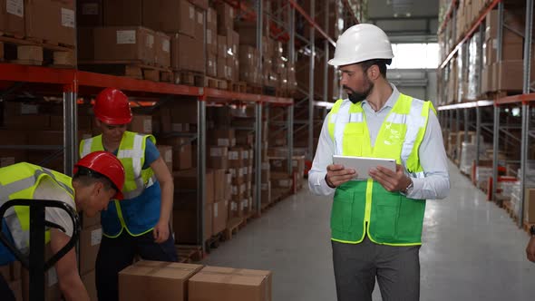Bearded Man Taking Inventory of Goods in Warehouse
