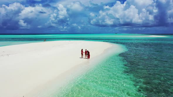 Beautiful women enjoying life on exotic resort beach wildlife by blue lagoon with clean sand backgro