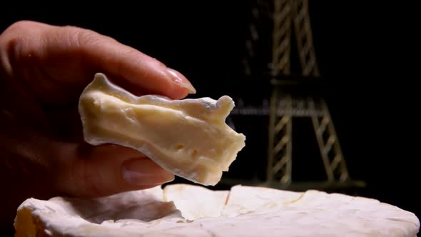 Fingers Squeeze a Sector of Soft French Cheese
