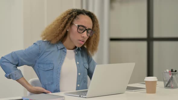 African Woman Having Back Pain While Using Laptop