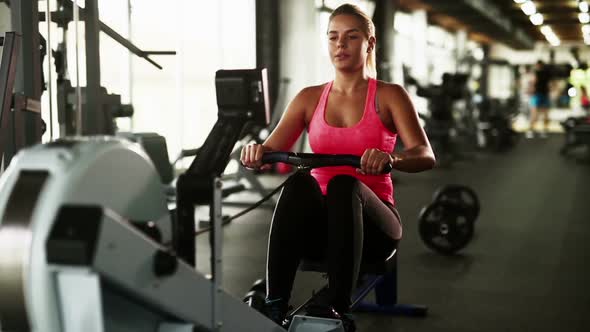 Woman Working Out in Gym on Machine