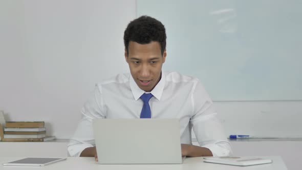 Angry Afro-American Businessman Reacting To Financial Loss at Work