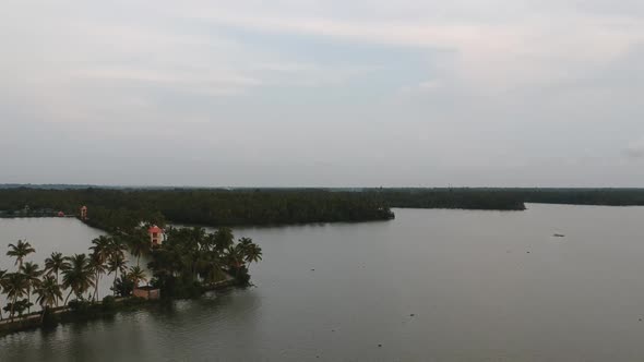 Beautiful aerial shot of a backwater,shore of vembanad lake, canal, sunset