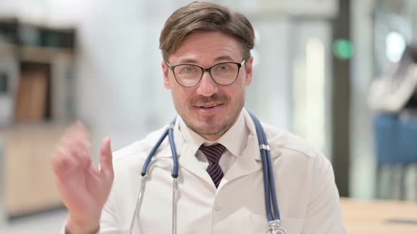 Portrait of Male Doctor Talking on Online Video Chat