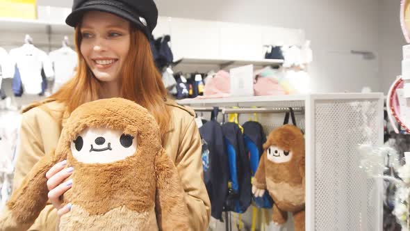 Cute Young Caucasian Woman Choosing Gifts in Mall