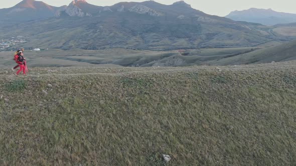 A Group of Hikers Walk the Hill Top at the Dusk