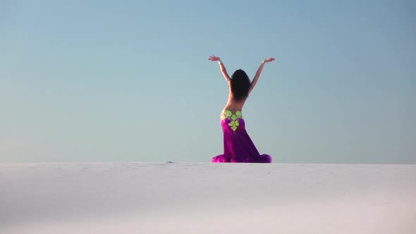 Graceful Dancer Against the Sky Dancing Belly Dance in a Brilliant Outfit. Slow Motion