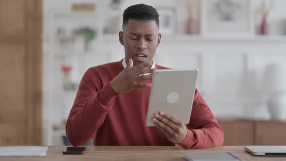 African Man having Loss on Tablet inn Office