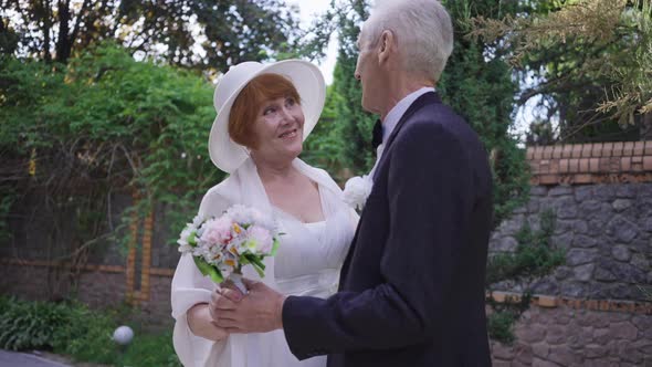 Loving Senior Couple Dancing in Slow Motion Outdoors on Wedding Day