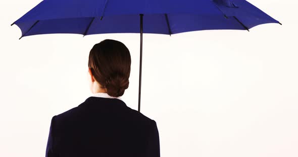 Businesswoman standing and holding umbrella