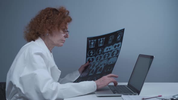 Female Radiologist Describes Patients Tomography Results By Typing on Laptop While Sitting in