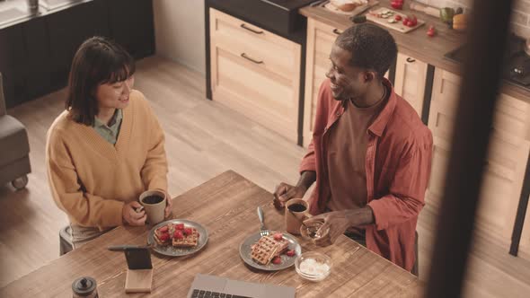 Multiethnic Couple Having Breakfast at Home