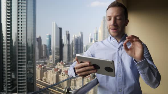 Attractive Young Business Man in City Office Working on Mobile Digital Tablet Computer Device