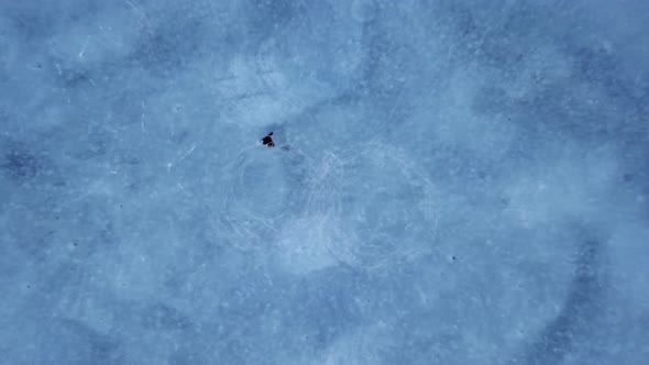 Aerial of Skating on a Frozen Lake