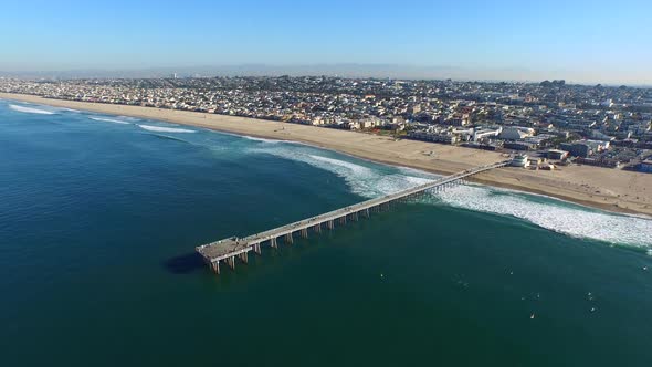 Aerial shot of surfers paddling out on the ocean.