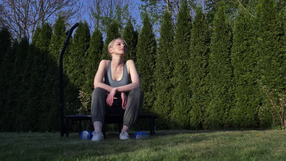 Woman rest after sport workout with dumbbells in outdoor