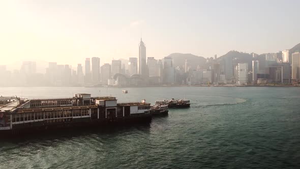 Ferry Boats Swifty Cruising Across The Calm Sea Water Near Wan Chai Pier In Hong Kong With Scenic Ci