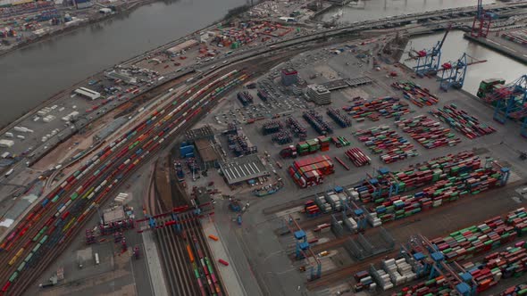 Aerial View of Large Cargo Container Terminal in Hamburg with Reveal of the River and City