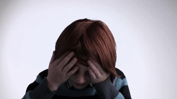 Red haired boy looking up at camera and smiling