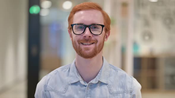 Portrait of Smiling Casual Redhead Man Looking at Camera 
