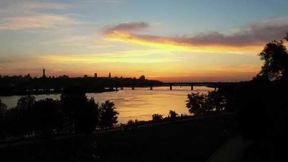 City Park with River and Bridge and Twilight Sunset Sky