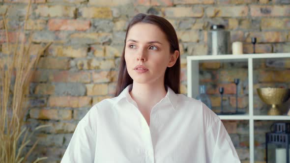Young Attractive Businesswoman Sitting in Office and Thinking About Something