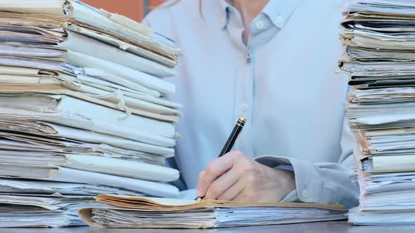 Business Concept. Young businesswoman putting signature on paper