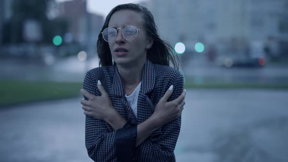 Young Businesswoman is Walking in the City While It is Raining