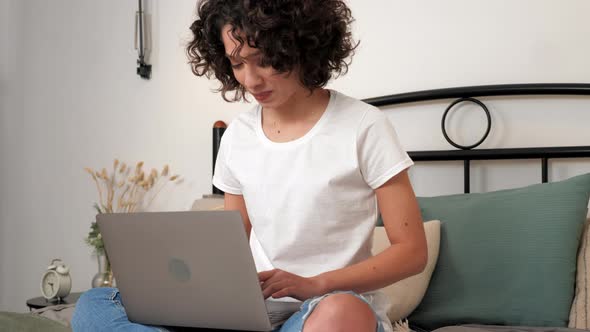 Smiling Hispanic Curly Woman Student Study Uses Laptop Distance Education