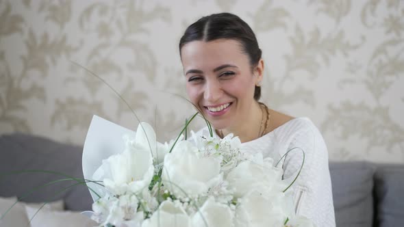 Cheerful Woman with Bouquet of Flowers