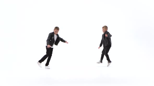 Little Boys Are Dancing a Modern Dance on the White Background in Black Leather Jackets and Jeans