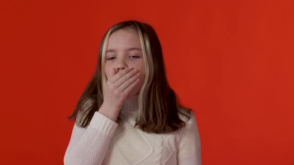 Little Girl Coughs Isolated on Red Background in Studio