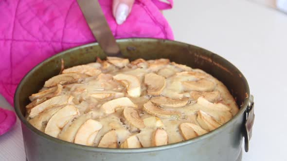 Baked Apple Pie In A Metal Mold. A Woman Cooks Charlotte At Home. Shooting The Camera On The Slide