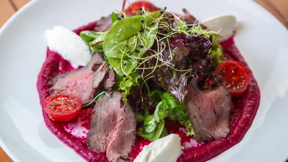 Delicious salad with beef meat, feta cheese and fresh vegetables