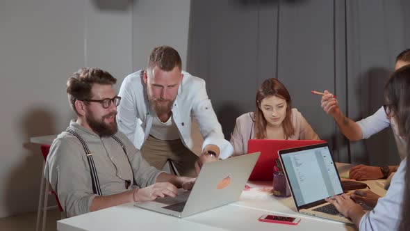 Young Cheerful Men Are Chatting at Business Meeting in Modern Company