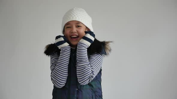 Cute Asian Girl In Winter Clothes On Gray Background Isolated Slow Motion