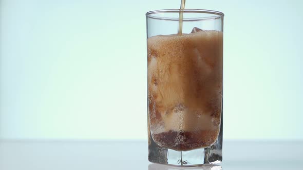 Pouring Cola with Ice Cubes Close-up, Cola with Ice and Bubbles in Glass, Coke Soda