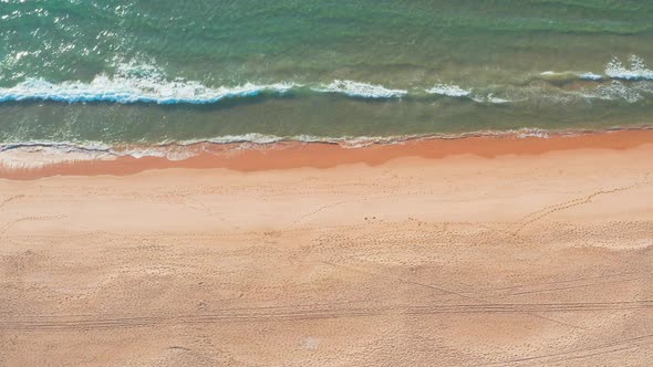 Flight Over the Sandy Beach and Waves