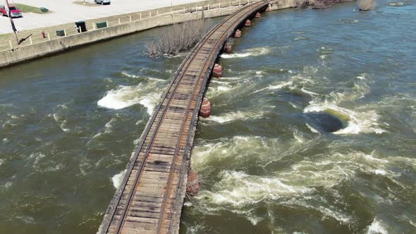 Aerial flight over train tracks crossing Fox river in Kaukauna, Wisconsin