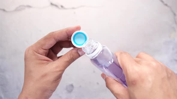 Mouthwash Liquid Flowing Into a Cap