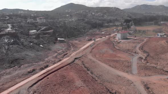 Burnt mountain village and forest after wildfire. 