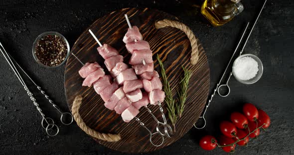 Raw Pork Kebab on Skewers Rotates on Tray. 